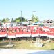 Ket Foto : Bupati Pulang Pisau H. Ahmad Rifa’i menyerahkan bendera Merah Putih kepada perwakilan kecamatan dalam Gerakan Pembagian Bendera Merah Putih di Lapangan Handep Hapakat, Jumat (1/8/2025).