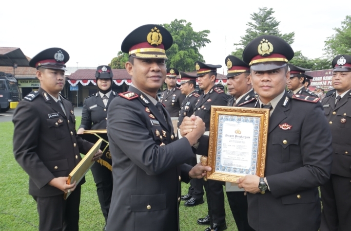 Kapolres Banjar AKBP Dr. Fadli menyerahkan penghargaan kepada personel berprestasi saat upacara HUT ke-80 RI di Mapolres Banjar.