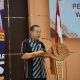 Rakhmat Dhany berdiri di podium membuka Musda PWRI Kabupaten Banjar di Aula KH Kasyful Anwar Martapura.
