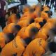 Tersangka kasus dugaan pelanggaran kesusilaan di Surabaya mengenakan baju tahanan oranye dan duduk berbaris di ruang pemeriksaan Polrestabes Surabaya.