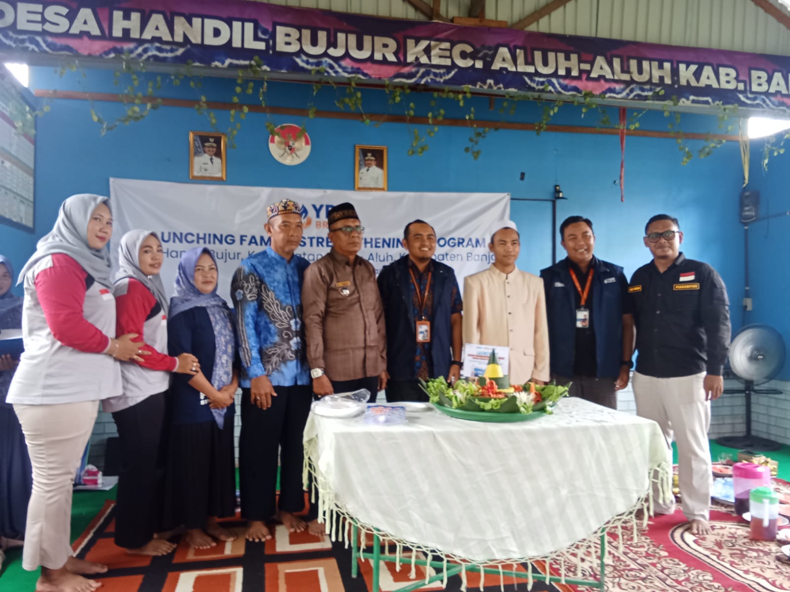 Pemotongan tumpeng oleh Kepala Desa Handil Bujur dan Supervisor YBM Brilian RO Banjarmasin pada acara Launching Family Strengthening Program di Balai Desa Handil Bujur.