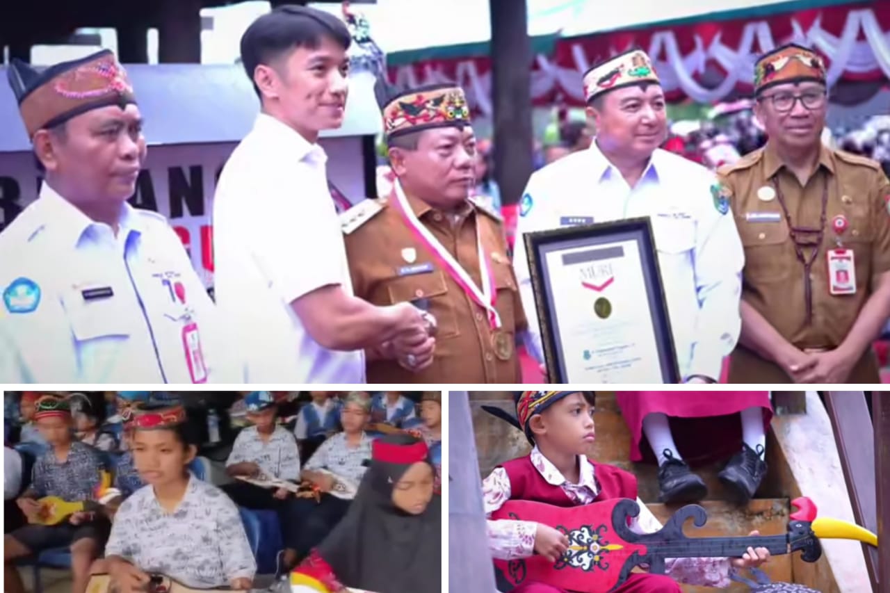 Ket Foto : Bupati Kapuas HM Wiyatno saat menerima piagam Rekor MURI yang diserahkan langsung oleh senior Manager MURI, Triyono, di Rumah Betang Maggatang Utus, Kelurahan Sei Pasah, Senin (8/12/2025). FOTO IST