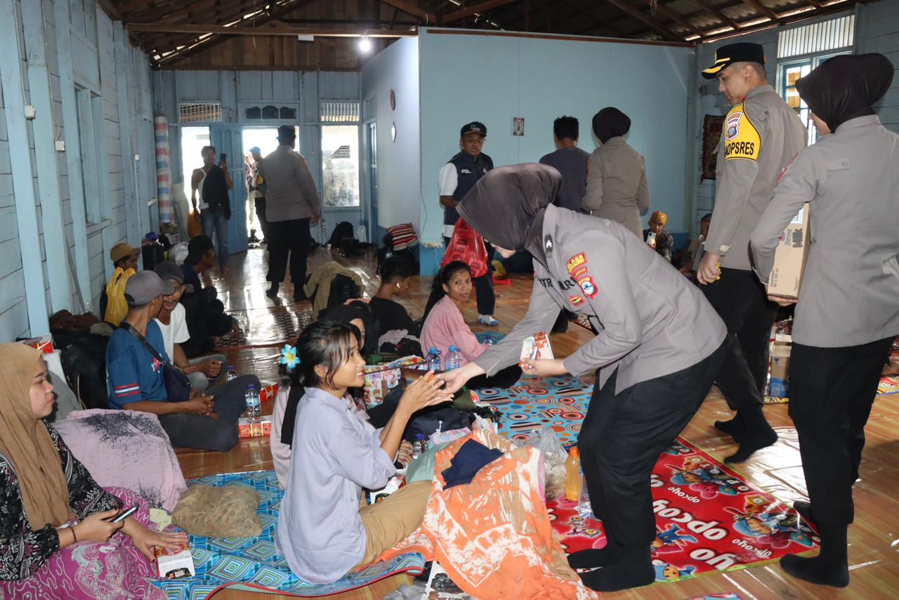 Wakapolres Tanah Bumbu bersama anggota polisi membagikan takjil kepada penumpang kapal Awu-Awu di penginapan dekat Pelabuhan Batulicin.