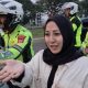 Polisi mengantar pemudik dengan sepeda motor setelah tertinggal di rest area Tol Cipali saat mudik Lebaran.
