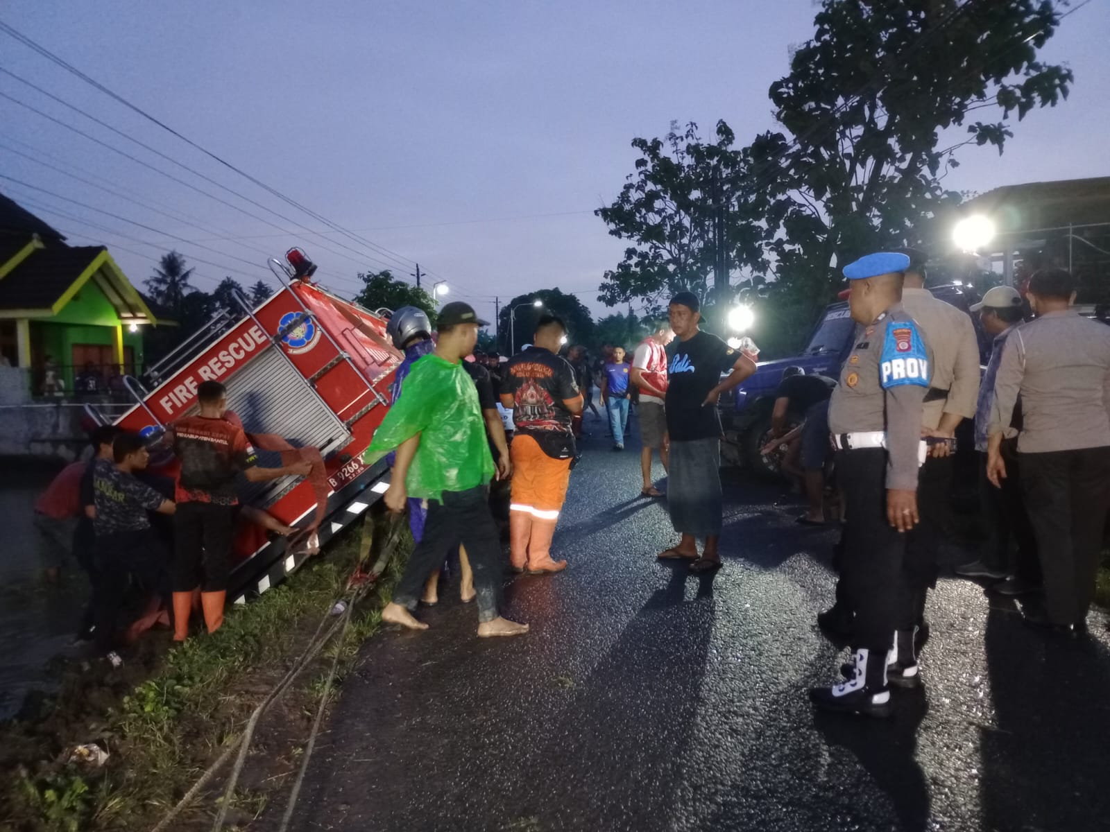 Mobil pemadam kebakaran terperosok ke sawah di Bantul dan dievakuasi oleh petugas serta warga di tengah kondisi jalan basah usai hujan.