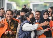 Dua orang pria dan wanita berjalan keluar dari gedung kejaksaan