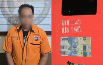 Enam plastik kecil sabu dan handphone di atas meja