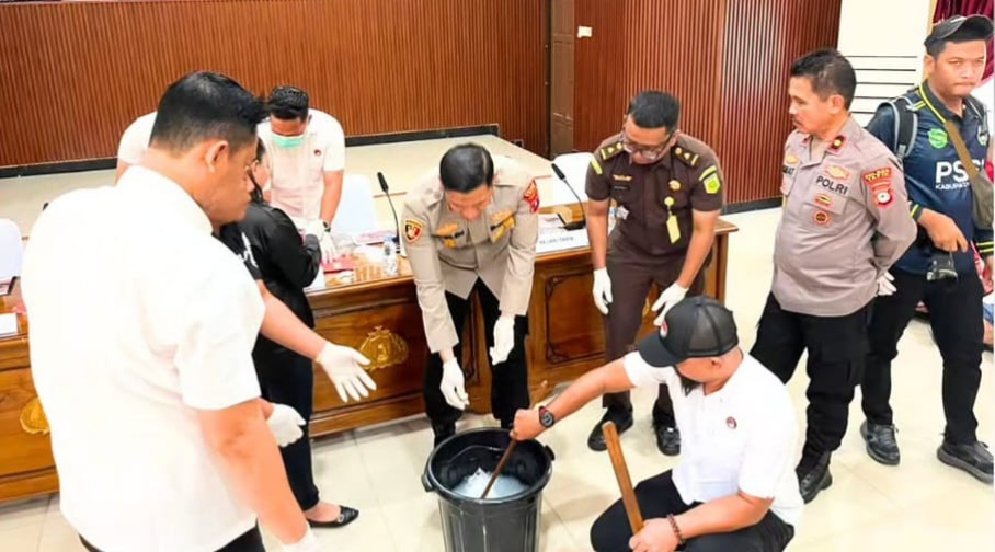 Beberapa pria berdiri di depan meja berisi plastik sabu